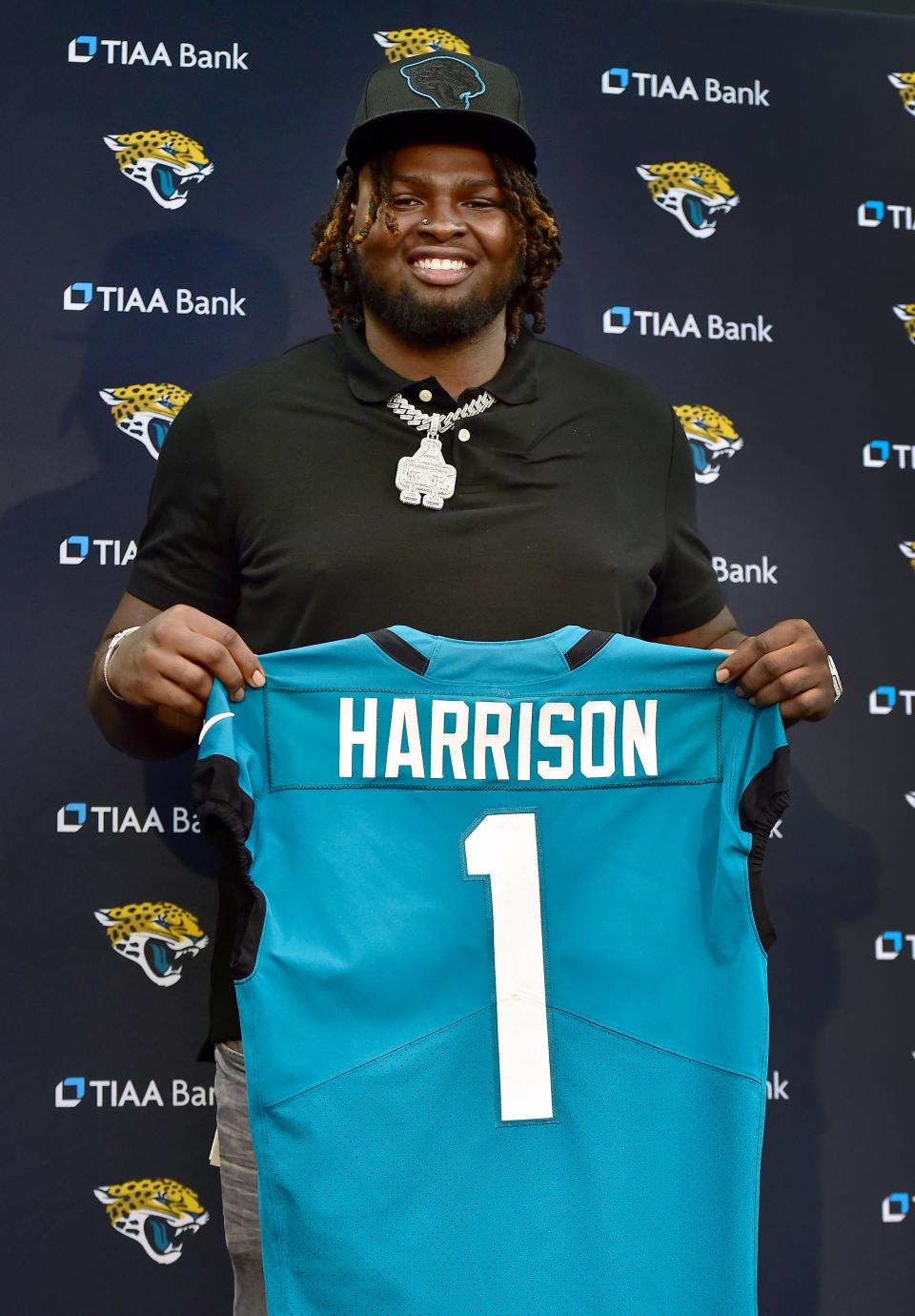 Jaguars first round draft pick Anton Harrison poses for photos with a Jaguars jersey after the press conference introducing him to the media. Anton Harrison arrived with his family as he made his first visit at TIAA Bank Field in Jacksonville, FL after being flown down from the Washington, DC area Friday, April 28, 2023. Harrison, an offensive tackle from the University of Oklahoma, became the Jacksonville Jaguars' first round selection in the 2023 NFL Draft, being the 27 overall pick late Thursday night.