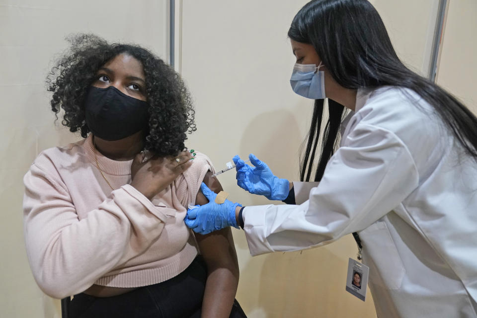 FILE - In this April 19, 2021, file photo, Keidy Ventura, 17, receives her first dose of the Pfizer COVID-19 vaccine in West New York, N.J. States across the country are dramatically scaling back their COVID-19 vaccine orders as interest in the shots wanes, putting the goal of herd immunity further out of reach. (AP Photo/Seth Wenig, File)