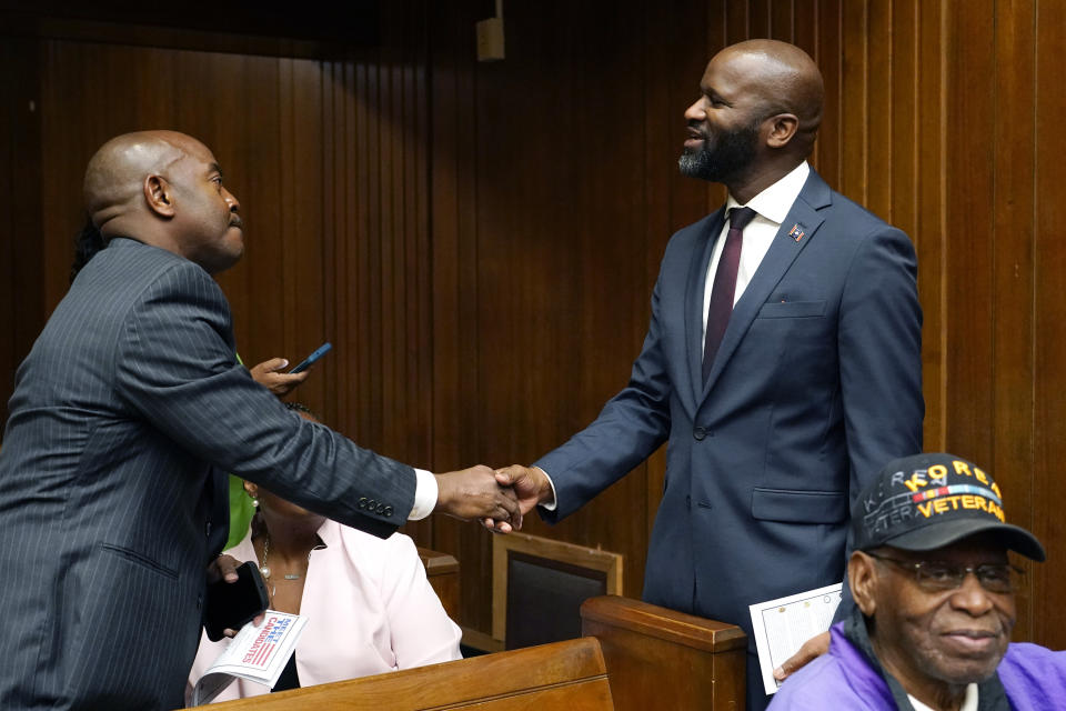 Ty Pinkins, Democratic nominee for Mississippi Secretary of State, right, greets an attendee at a candidates forum, sponsored by the Vicksburg branch of the NAACP, and several local chapters of National Pan-Hellenic Council members, Oct. 26, 2023, in Vicksburg, Miss. (AP Photo/Rogelio V. Solis)