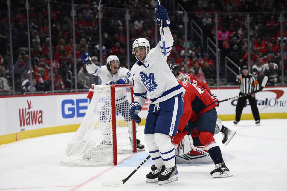 Toronto Maple Leafs center John Tavares, front, celebrates his goal against the Washington Capitals during the second period of an NHL hockey game Tuesday, Oct. 24, 2023, in Washington. (AP Photo/Nick Wass)