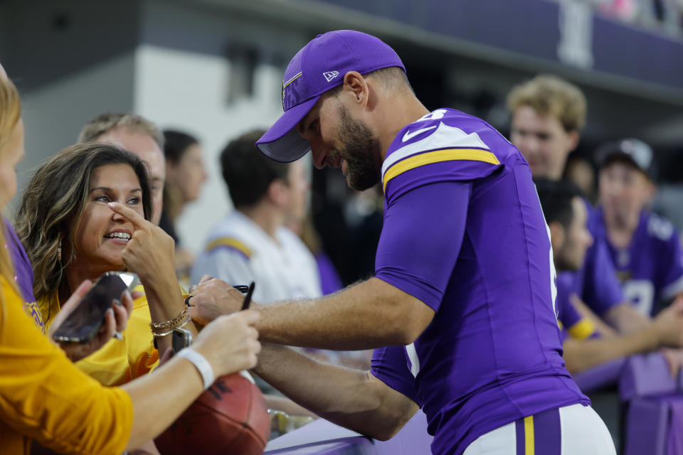 Minnesota Vikings quarterback Kirk Cousins signs autographs for fans during the first half of a preseason NFL football game against the Tennessee Titans, Saturday, Aug. 19, 2023, in Minneapolis. (AP Photo/Bruce Kluckhohn)