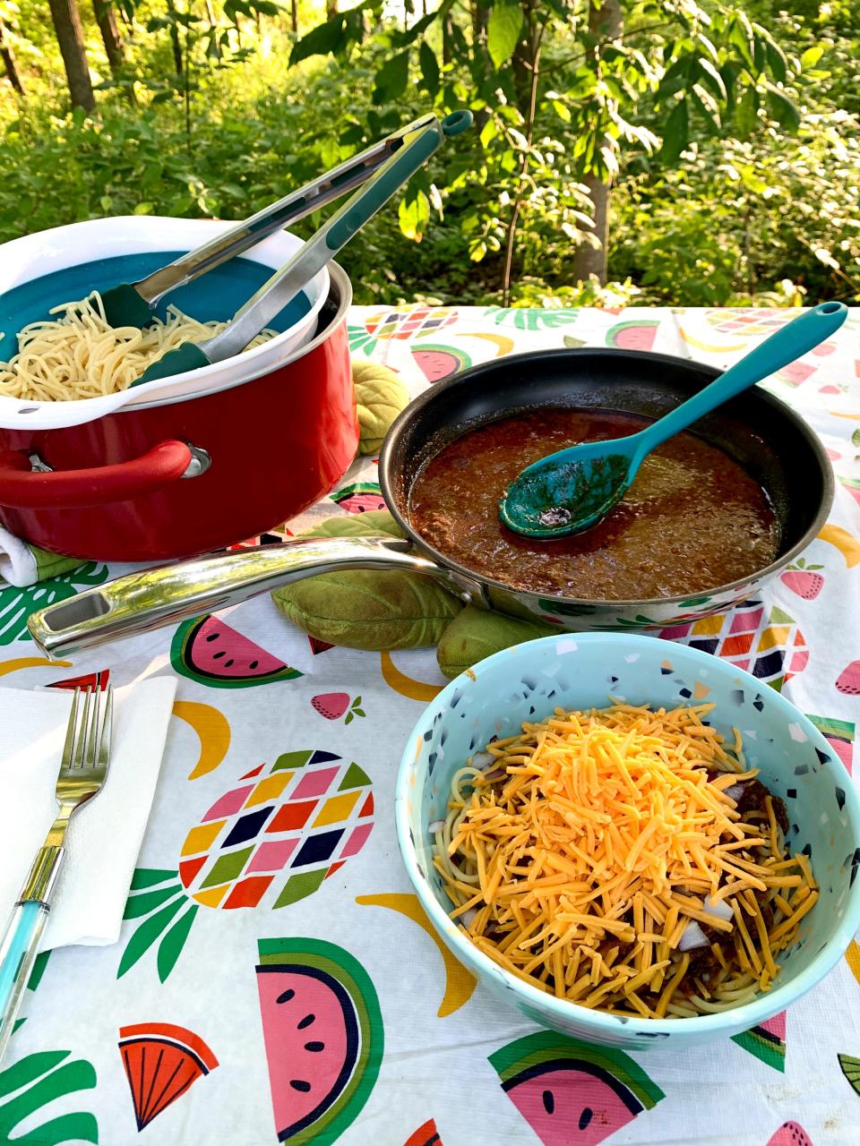 Jenna Beall Mueller and Adam Mueller make Skyline at the campground for dinner.