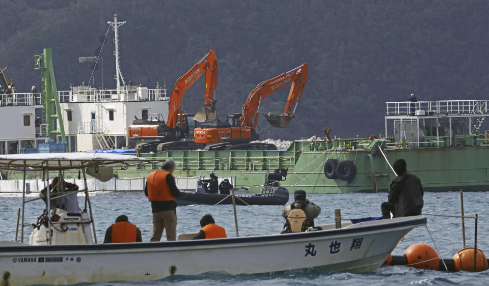 Protesters are seen on a boat as a reclamation work is resumed at a construction site off Henoko in Nago, Okinawa prefecture, southern Japan Wednesday, Jan. 10, 2024. Japan's central government on Wednesday forcibly resumed reclamation work at the planned relocation site of a disputed U.S. military base on the southern island of Okinawa despite persistent opposition and protests by residents and amid growing international criticisms that the move tramples on democracy and environment. (Kyodo News via AP)