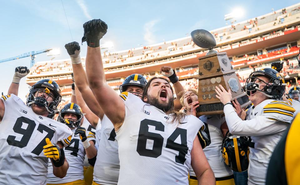 Nov 26, 2021; Lincoln, Nebraska, USA; Iowa Hawkeyes players hoist the Heroes Trophy following their win over the Nebraska Cornhuskers at Memorial Stadium.