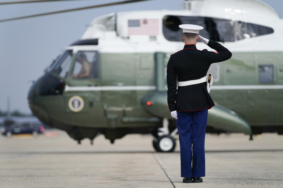 A soldier stands at attention as Marine One, with President Joe Biden aboard, lands Friday, Oct. 15, 2021, in Andrews Air Force Base, Md. (AP Photo/Evan Vucci)