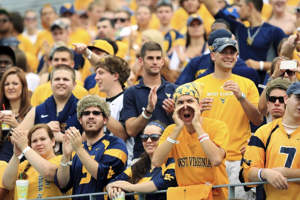 West Virginia students cheer during their NCAA college football game against Marshall in Morgantown, W.Va., Saturday, Sept. 1, 2012. West Virginia won 69-34. (AP Photo/Christopher Jackson)