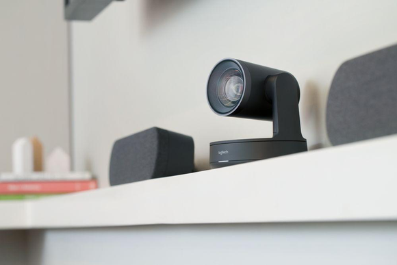 Logitech camera on a shelf in an office.