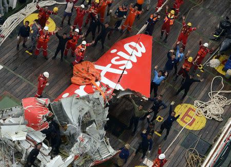 The tail of AirAsia QZ8501 passenger plane is seen on the deck of the Indonesian Search and Rescue (BASARNAS) ship Crest Onyx after it was lifted from the sea bed, south of Pangkalan Bun, Central Kalimantan in this January 10, 2015 file photo. REUTERS/Prasetyo Utomo/Pool/Files