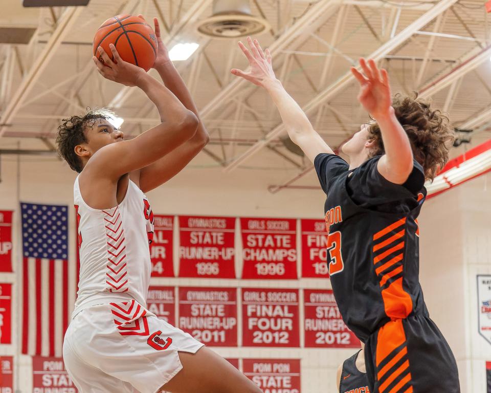 Canton's Dante Favor takes a shot while defended by Brighton's Eddie Millington during the Chiefs' 67-45 victory Friday, Feb. 17, 2023.