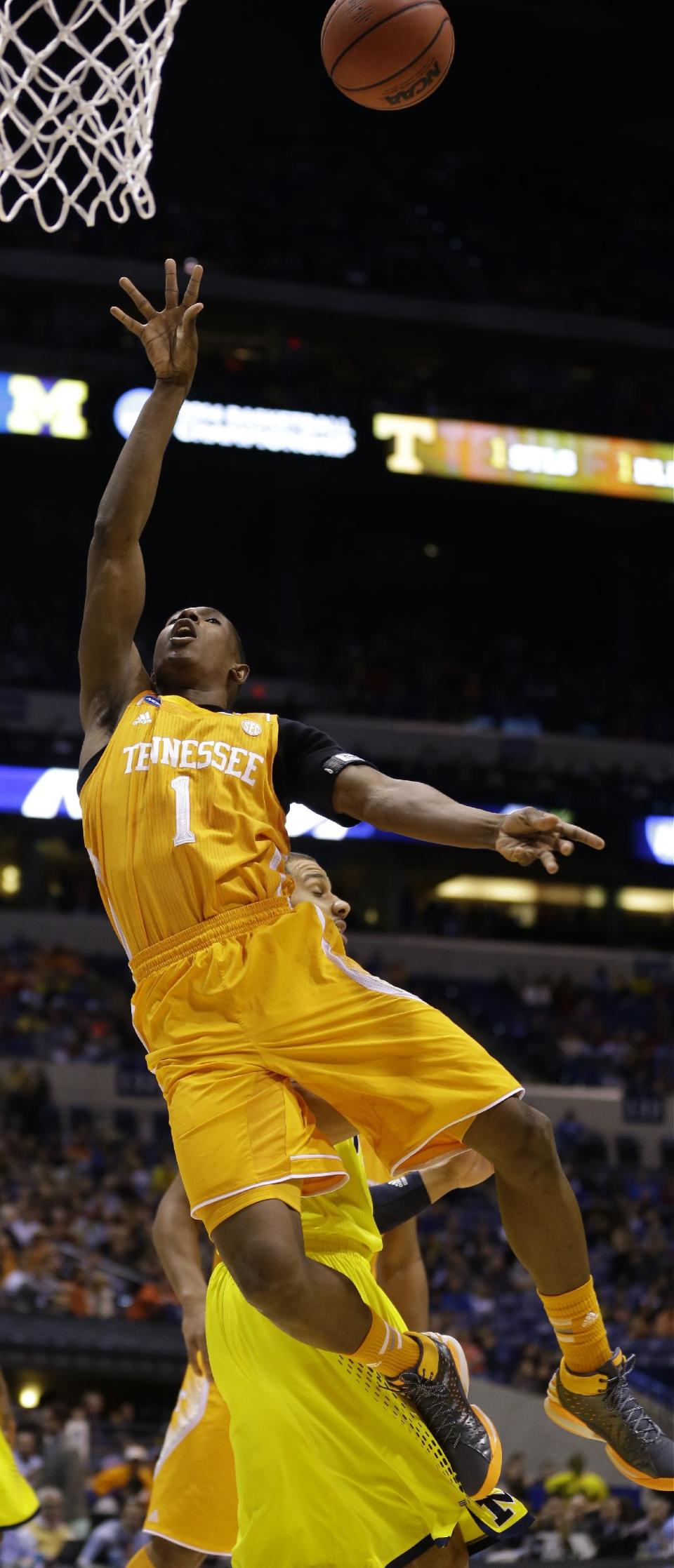 Tennessee's Josh Richardson (1) shoots over Michigan's Jordan Morgan during the first half of an NCAA Midwest Regional semifinal college basketball tournament game Friday, March 28, 2014, in Indianapolis. (AP Photo/Michael Conroy)