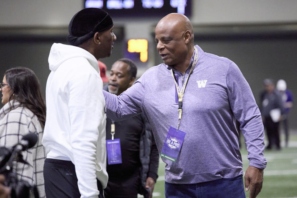 Washington quarterback Michael Penix Jr., left, is greeted by former NHL quarterback Warren Moon at the end of Washington's NFL Pro Day, Thursday, March 28, 2024, in Seattle. (AP Photo/John Froschauer)
