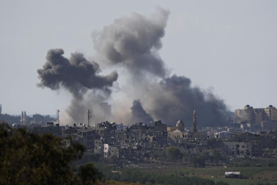 Clouds of smoke rise over buildings