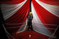 The body of boxer Christopher Rivera, who was shot to death on Sunday, is propped up in a fake boxing ring during his wake at the community recreation center within the public housing project where he lived in San Juan, Puerto Rico, Friday, Jan. 31, 2014. Elsie Rodriguez, vice president of the Marin funeral home, explained that Rivera had asked his family that if he died, he wanted his funeral to make reference to his boxing career. (AP Photo/Ricardo Arduengo)