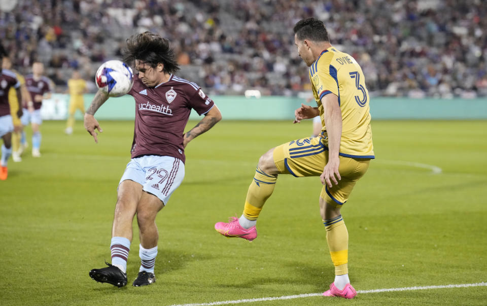 Colorado Rapids midfielder Braian Galván, left, stops a kick by Real Salt Lake defender Bryan Oviedo, right, in the second half of an MLS soccer match Saturday, May 20, 2023, in Commerce City, Colo. (AP Photo/David Zalubowski)