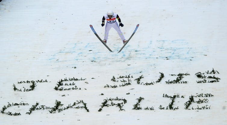 <span class="caption">Soaring over ‘Je suis Charlie’ in the ski jumping leg of the FIS Nordic Combined World Cup in France, 10 January 2015.</span> <span class="attribution"><span class="source">Patrick Seeger/EPA-EFE</span></span>