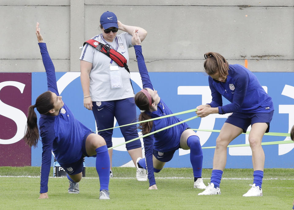 From left United States players Alex Morgan, Rose Lavelle and Kelley O'Hara warm up during a training session at the Terrain d'Honneur Lucien Choine stadium a day before the Group F soccer match between United States and Chile at the Women's World Cup in Paris, Saturday, June 15, 2019. (AP Photo/Alessandra Tarantino)