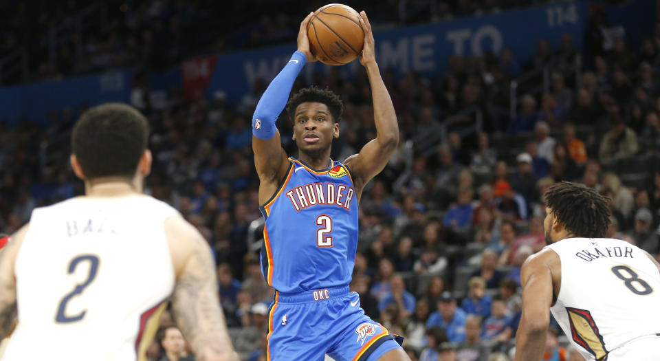 OKLAHOMA CITY, OK - NOVEMBER 02: Shai Gilgeous-Alexander #2 of the Oklahoma City Thunder looks off New Orleans Pelicans defenders at Chesapeake Energy Arena on November 2, 2019 in Oklahoma City, Oklahoma. NOTE TO USER: User expressly acknowledges and agrees that, by downloading and/or using this Photograph, user is consenting to the terms and conditions of the Getty Images License Agreement. (Photo by Ron Jenkins/Getty Images)