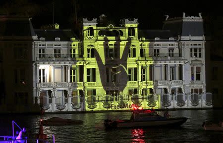 The Rabia sign is projected on the Egyptian Consulate during a protest against an Egyptian court's decision to sentence deposed President Mohamed Mursi to death, in Istanbul, Turkey, late June 16, 2015. REUTERS/Murad Sezer