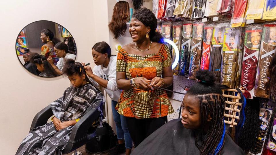 Sonia Ekemon, center, styles box braids for her daughter, Catherine Ekemon, 12, at African Braiding Salon by Sonia Ekemon, her business located inside Phenix Salon Suites in Meridian, March 21, 2023. Ekemon was part of lawsuit in 2022 against the state’s Idaho Barber and Cosmetology Services Licensing Board for the right to braid hair without a license. Since the requirement for a cosmetology license was dropped, Ekemon has finally been able to open a legal storefront for her hair braiding services.