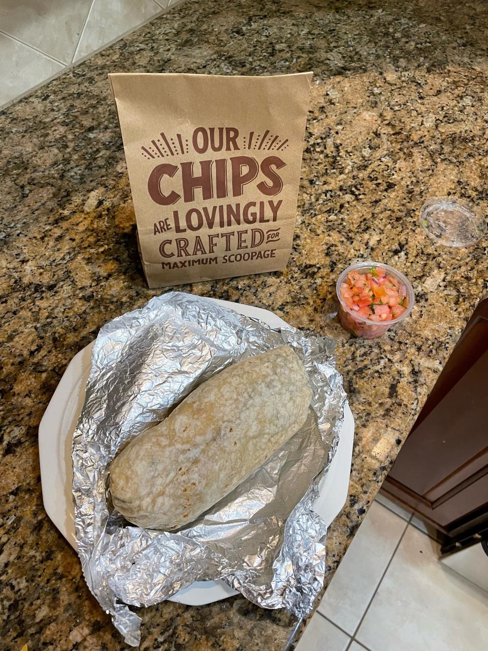 A 54-year-old Fayetteville pharmacist eats a Chipotle burrito with pico de gallo.