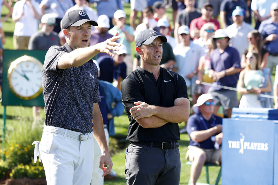 PONTE VEDRA BEACH, FL - MARCH 14: PGA golfer Rory McIlroy talks with Jordan Spieth on where his tee shot on the 18th hole went in the water during The Players Championship on March 14, 2024, at TPC Sawgrass in Ponte Vedra Beach, Florida. (Photo by Brian Spurlock/Icon Sportswire via Getty Images)