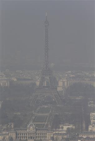 A general view shows the Eiffel tower and the Paris skyline through a small-particle haze March 13, 2014 as warm and sunny weather continues in France. Residents and visitors to Paris basking in a streak of unseasonable sunshine were also being treated with a dangerous dose of particles from car fumes that pushed air pollution to levels above other northern European capitals this week. REUTERS/Philippe Wojazer
