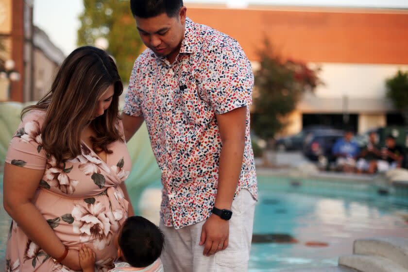 LOS ANGELES, CA - SEPTEMBER 04: Stephanie, Kevin and their son Kruz Zapata, 2, hang at the Monrovia public library in Monrovia on Friday, Sept. 4, 2020 in Los Angeles, CA.Stephanie's second baby is due in December and Kevin will have job protections in order to take family leave under a bill Gov. Gavin Newsom is expected to sign that will give millions of workers at smaller businesses job protections for parental leave. (Dania Maxwell / Los Angeles Times)