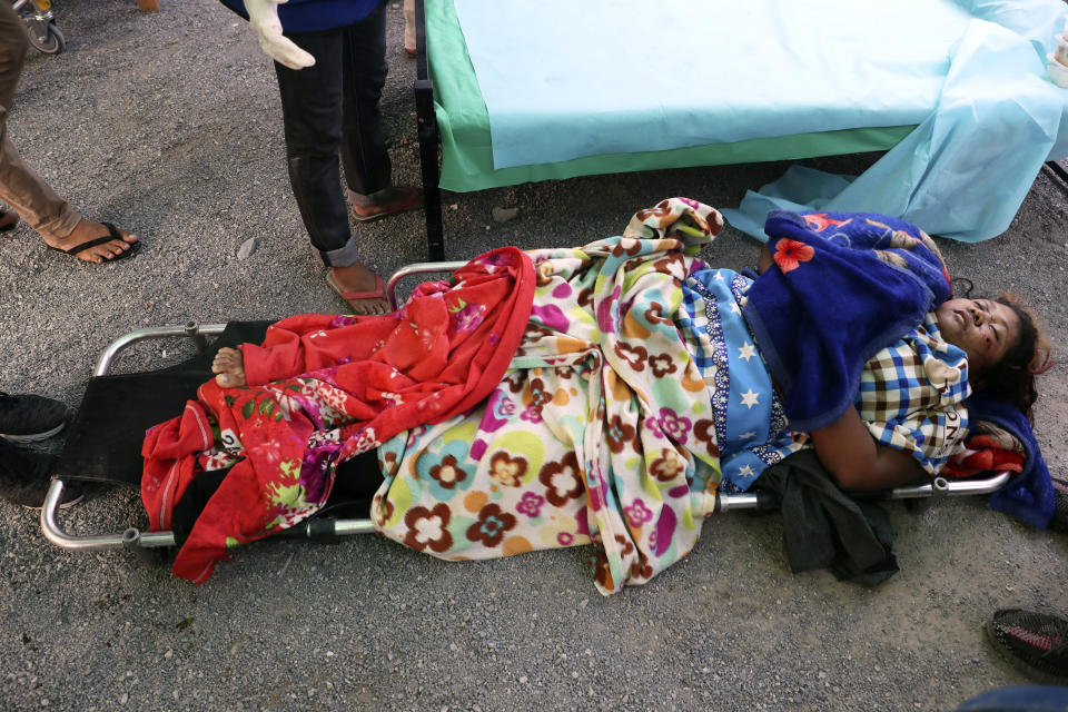 A woman lies on a stretcher in Mandalay, Myanmar Sunday, March 14, 2021. At least four people were shot dead during protests in Myanmar on Sunday, as security forces continued their violent crackdown against dissent following last month's military coup. (AP Photo)
