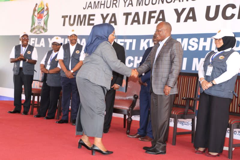 Tanzania's re-elected President John Pombe Magufuli greets Tanzania's Vice President Samia Suluhu Hassan after receiving the winning certificate at the National Electoral Commission (NEC) headquarters in the Njedengwa suburb of Dodoma
