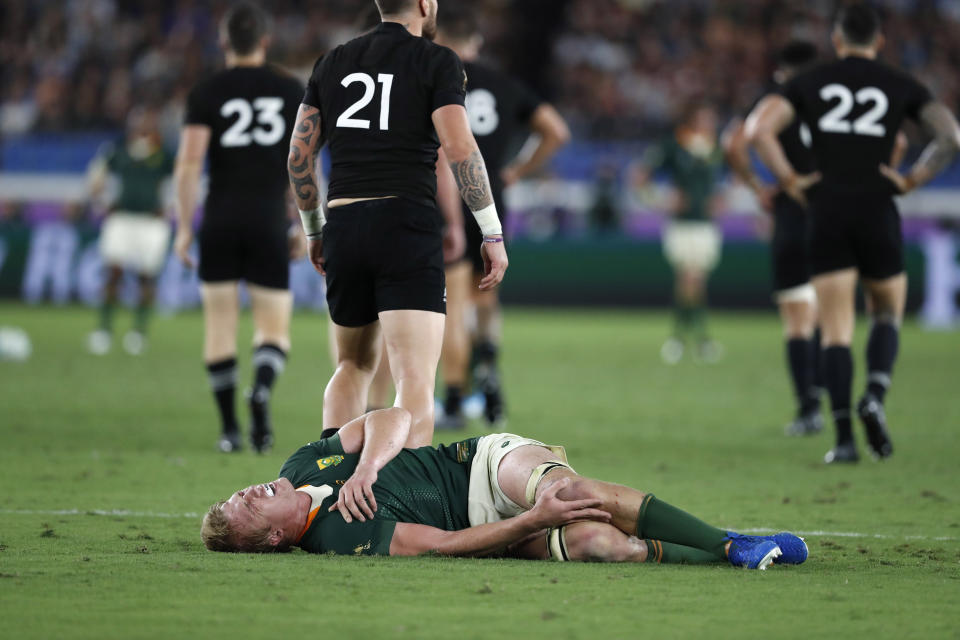 South Africa's Pieter-Steph du Toit cringes in pain after being injured during the Rugby World Cup Pool B game between New Zealand and South Africa in Yokohama, Japan, Saturday, Sept. 21, 2019. (AP Photo/Shuji Kajiyama)