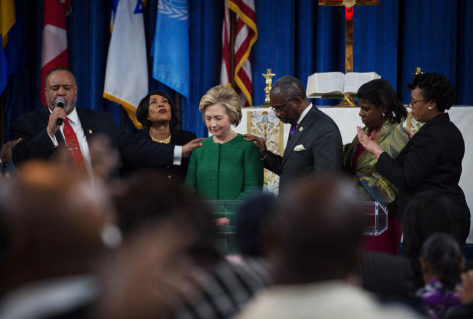 Hillary bows in prayer