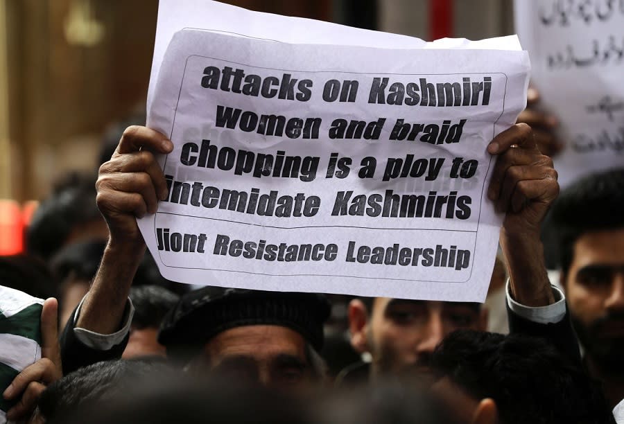 Activists of separatist groups hold placards during a protest against alleged braid chopping incidents in Srinagar: EPA/Farooq Khan