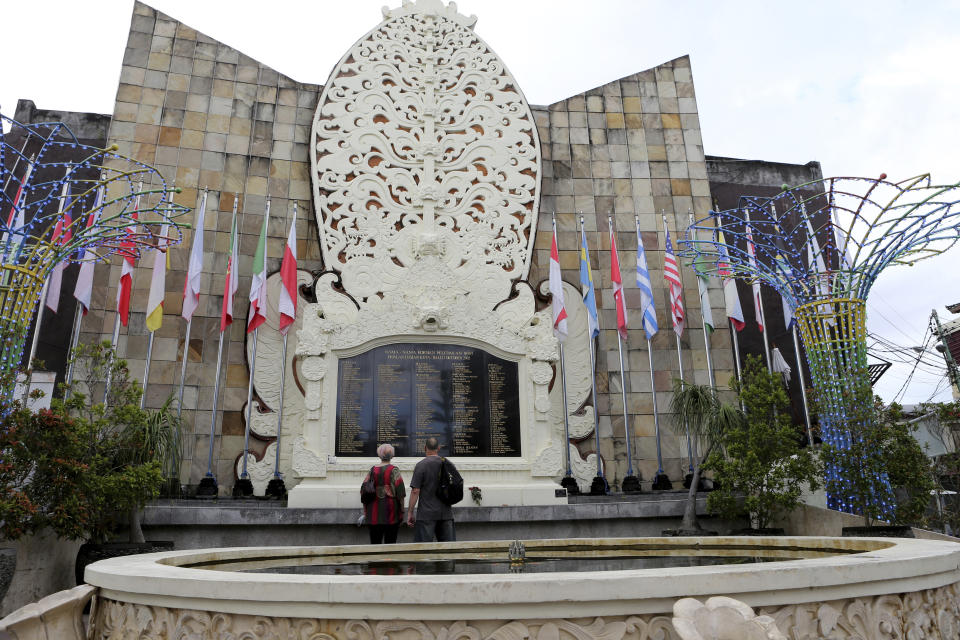 Australian tourists Gerry and Selina Dunstan visit the Bali Bombing Memorial Monument in Kuta, Bali, Indonesia, on Oct. 4, 2022. Two decades after a few Bali bombings, counterterrorism efforts in the world's most populous Muslim country remain highly active. More than 2,300 people have been arrested on terrorism charges, according to the Center for Radicalism and Deradicalization Studies, since a national counterterrorism unit, known as Densus 88, was established in the wake of the attacks. (AP Photo/Firdia Lisnawati)