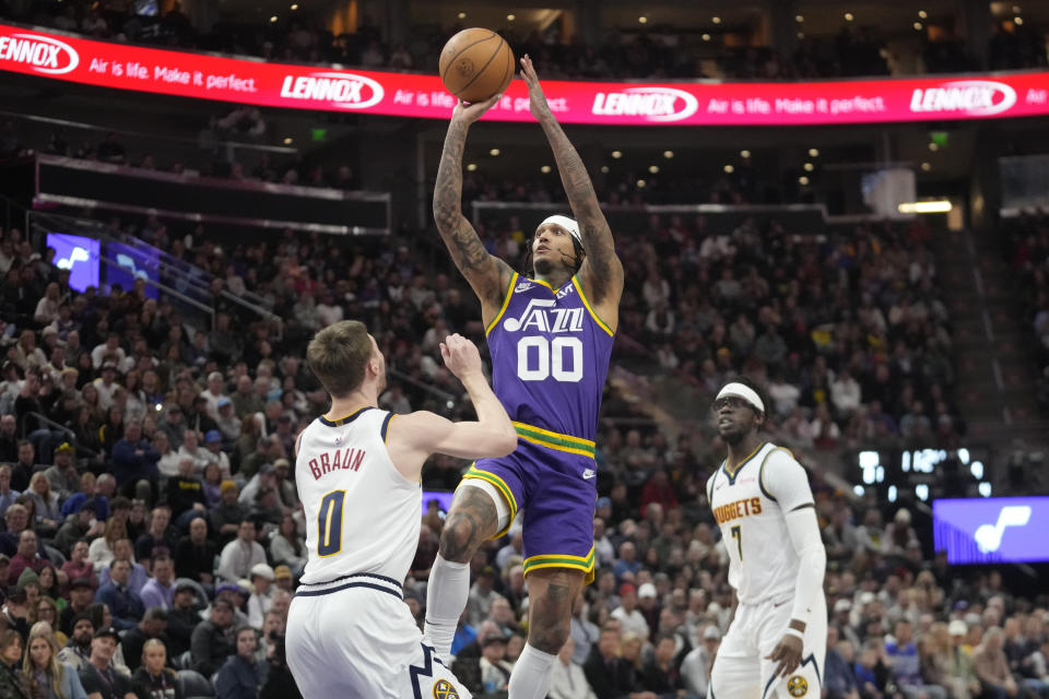 Utah Jazz guard Jordan Clarkson (00) shoots in front of Denver Nuggets guard Christian Braun (0) during the second half of an NBA basketball game Wednesday, Jan. 10, 2024, in Salt Lake City. (AP Photo/Rick Bowmer)