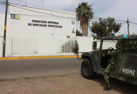 A soldier stands guard outside the Forensic Medical Service (SEMEFO) after the arrival of the body of Francisco Zazueta, also known as "Pancho Chimal," in Culiacan, in Mexico's northern Sinaloa state April 15, 2017. REUTERS/Jesus Bustamante