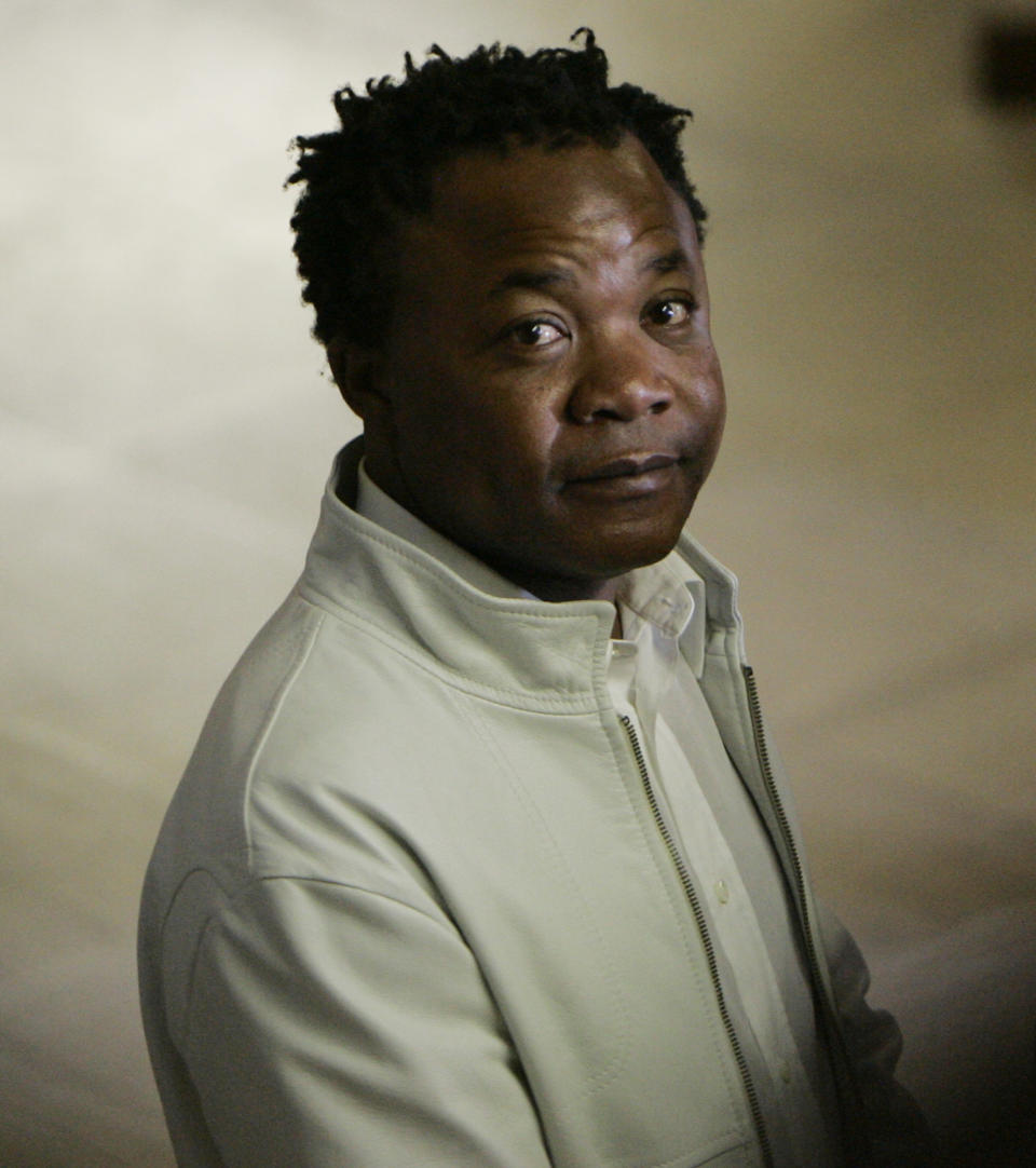 FILE- Congolese pub owner Diya "Patrick" Lumumba who was originally jailed for the murder of Meredith Kercher, looks on outside Perugia's court, central Italy, Tuesday Sept. 16, 2008. Amanda Knox faces yet another trial for slander against Lumumba in a case that could remove the last remaining guilty verdict against her eight years after Italy's highest court definitively threw out her conviction for the murder of her 21-year-old British roommate, Meredith Kercher. (AP Photo/Antonio Calanni, File)