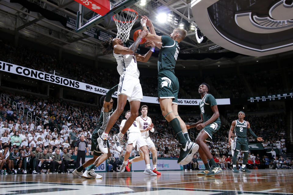 Southern Indiana's Javius Moore, left, and Michigan State's Carson Cooper fight for a rebound during the second half of an NCAA college basketball game, Thursday, Nov. 9, 2023, in East Lansing, Mich. (AP Photo/Al Goldis)