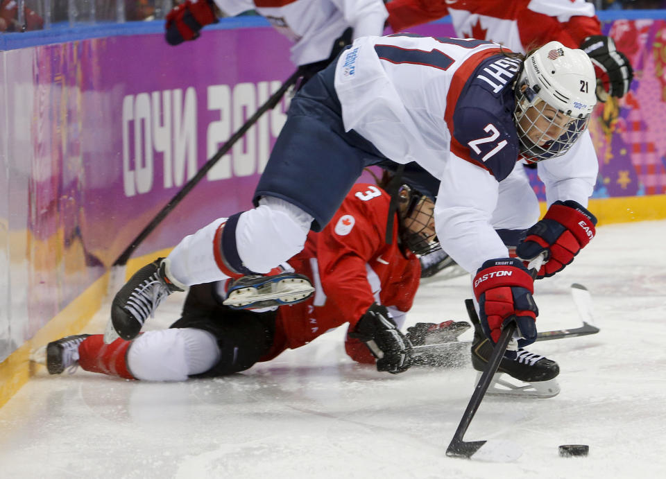 Hilary Knight of the United States (21) passes the puck against Canada during the first period of the women's gold medal ice hockey game at the 2014 Winter Olympics, Thursday, Feb. 20, 2014, in Sochi, Russia. (AP Photo/Mark Humphrey)