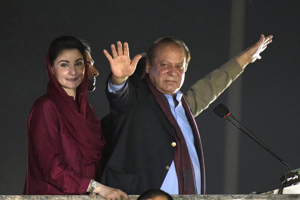 Pakistan's former Prime Minister Nawaz Sharif, center waves to his supporters upon his arrival to address a welcoming rally, in Lahore, Pakistan, Saturday, Oct. 21, 2023. Sharif returned home Saturday on a special flight from Dubai, ending four years of self-imposed exile in London as he seeks to win the support of voters ahead of parliamentary elections due in January. (AP Photo/Anjum Naveed)