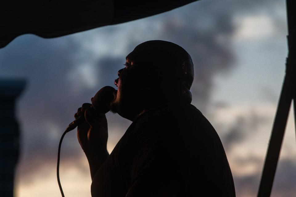 A musician performs rap and other hits at the Juneteenth Festival at Water's Edge Park on Saturday, June 18, 2022. Hundreds of people came to listen to live music, visit food trucks, play games and access services.