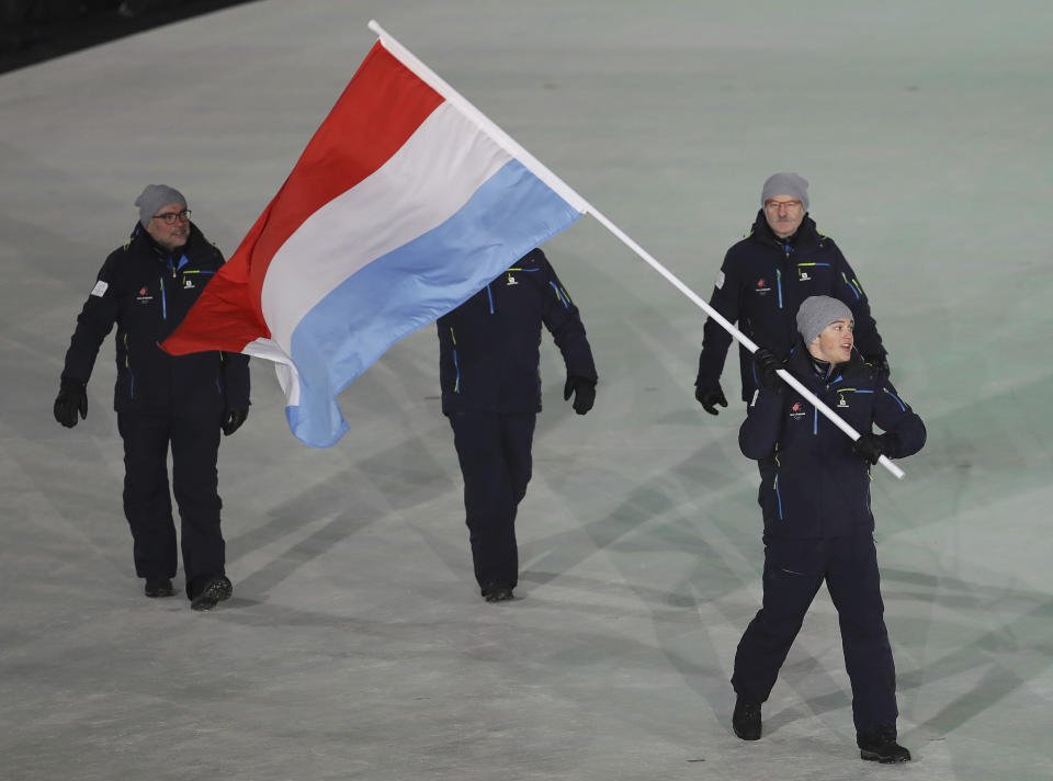 <p>Matthieu Osch carries the flag of Luxembourg during the opening ceremony of the 2018 Winter Olympics in Pyeongchang, South Korea, Friday, Feb. 9, 2018. (AP Photo/Michael Sohn) </p>