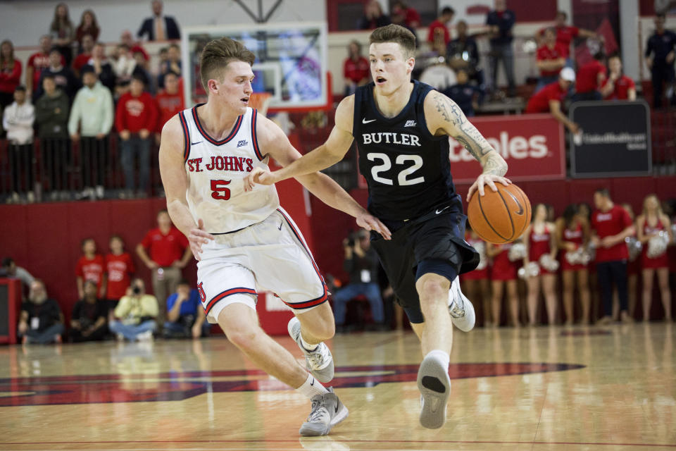 Butler forward Sean McDermott (22) us defended by St. John's guard David Caraher (5) during the first half of an NCAA college basketball game Tuesday, Dec. 31, 2019, in New York. (AP Photo/Julius Constantine Motal)