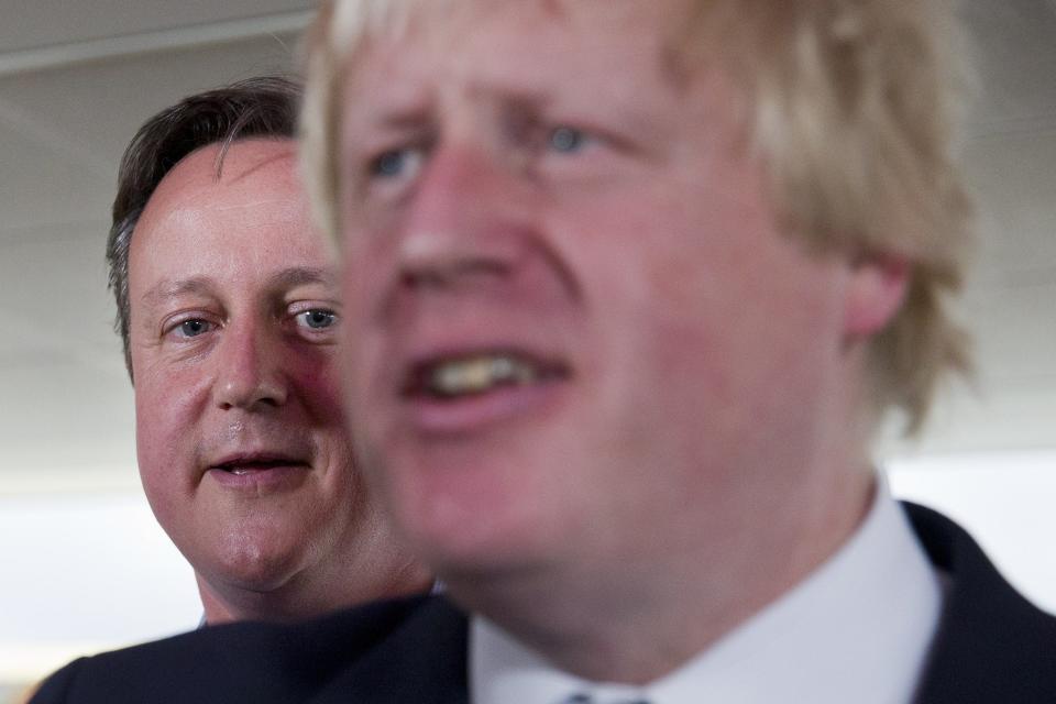 London Mayor Boris Johnson, right, and British Prime Minister David Cameron speak at a Conservative party election rally in Hendon in north London on May 5, 2015.