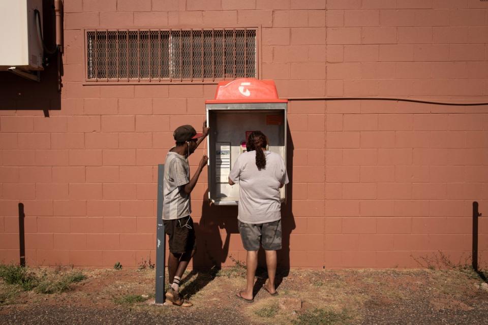 Rosemary and Jonathan use the landline phone booth, as the local phone tower is out of service (Reuters)