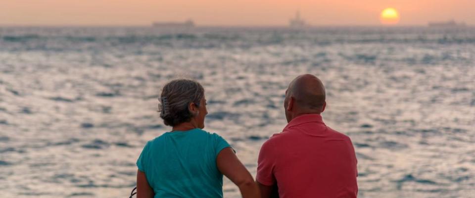 Oranjestad, Aruba - January 8, 2018: A couple admire a romantic sunset in Oranjestad.