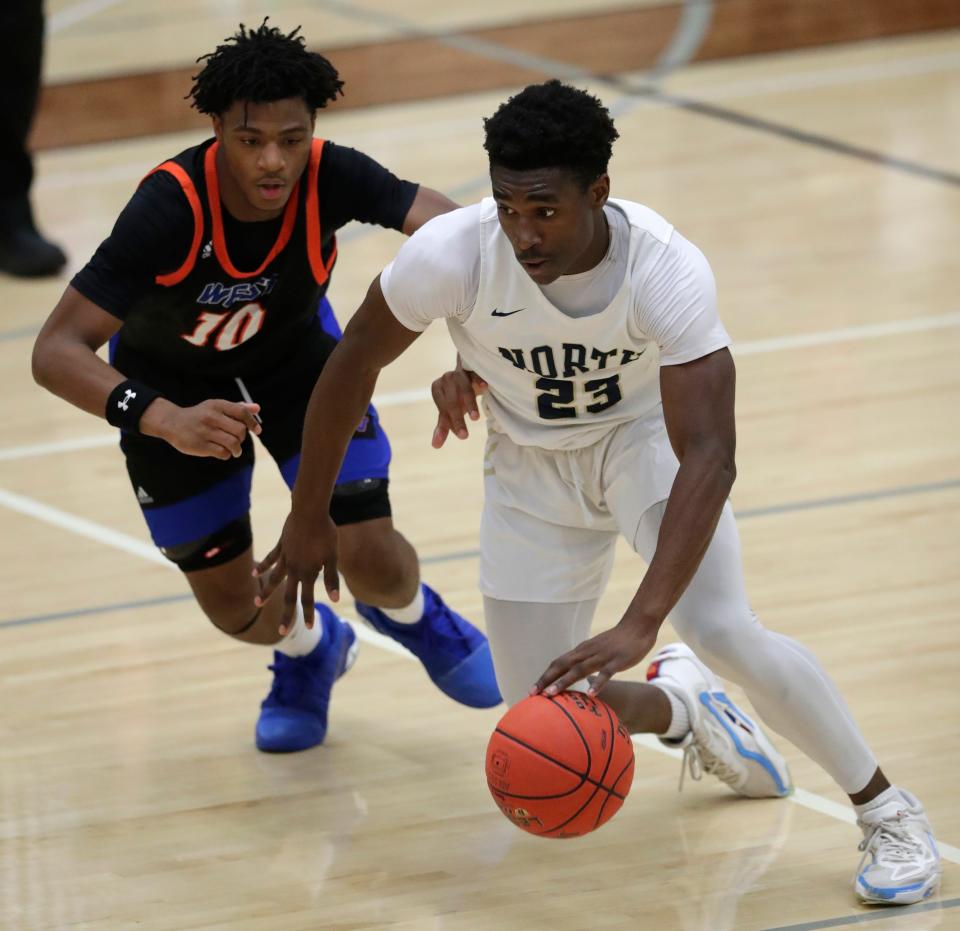 Appleton North's Abraham Tomori, right, drives to the basket against Appleton West's Parrion Peace during their game Dec. 8 at Appleton North.