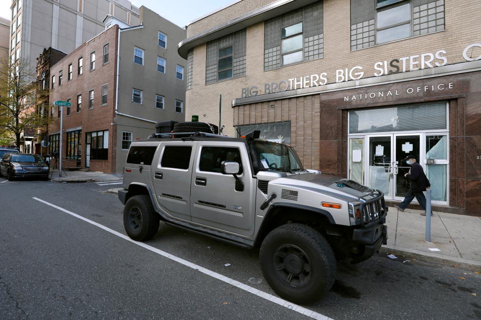 A parking violation envelope is affixed to the windshield of a Hummer vehicle parked near the Pennsylvania Convention Center where votes are being counted, Friday, Nov. 6, 2020, in Philadelphia.