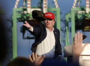 <p>Presumptive Republican presidential candidate Donald Trump throws a baseball cap from the stage after speaking to supporters at a campaign event aboard the USS Iowa in Los Angeles, Tuesday, Sept. 15, 2015.<i> (Photo: Kevork Djansezian/AP)</i> </p>