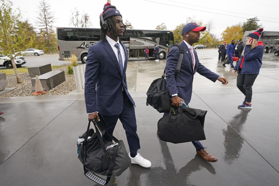 Arizona football players arrive at Rice-Eccles Stadium before their NCAA college football game against Utah Saturday, Nov. 5, 2022, in Salt Lake City. College athletic programs of all sizes are reacting to inflation the same way as everyone else. They're looking for ways to save. Travel and food are the primary areas with increased costs. (AP Photo/Rick Bowmer)