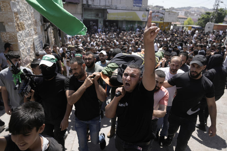 Mourners carry the body of Mustafa Marhi, an Islamic Jihad militant killed in a raid by Israeli forces in the village of Kafr Dan, near the West Bank city of Jenin, Wednesday, June 12, 2024. Hundreds of mourners gathered for the funeral of Palestinian men killed by Israeli fire during a raid in the northern West Bank village. A total of six men were killed by Israeli forces during Tuesday's raid on the village according to the Palestinian Health Ministry. (AP Photo/Majdi Mohammed)